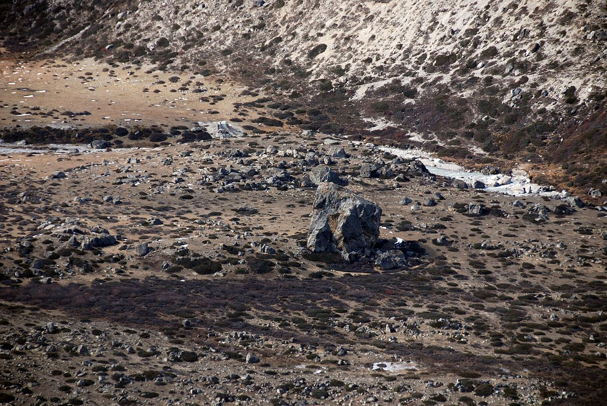 13 The Big Rock Of Drakpochen With Campsite Across The Bridge Gyan and I reach the big rock at Drakpochen (4139m) around 14:00, expecting our crew and the local Nyalam yak herders and yaks to already be there so we could continue on to Shingdip. Gyan and I waited until almost 17:00 for them to arrive and had to stay at Drakpochen for the night. My Tibetan guide explained that the yak herders did not show up at Nyalam until 3 hours late. When I explained through my Tibetan guide that I wanted to do direct to Advanced Base Camp the next day, I understood what the tardy yak herders were up to when they demanded additional payment to have such a long day. I was stuck. I paid the extra money.